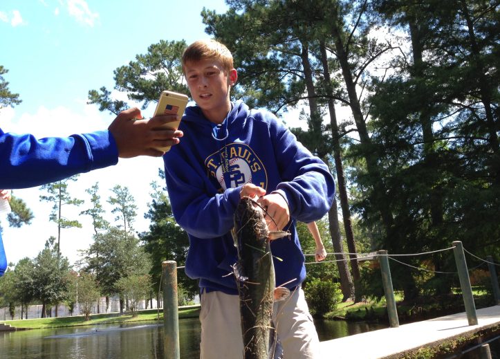 Freshman Dominick O'Brien catches a catfish from pond. (Photo by Tyler Petro)